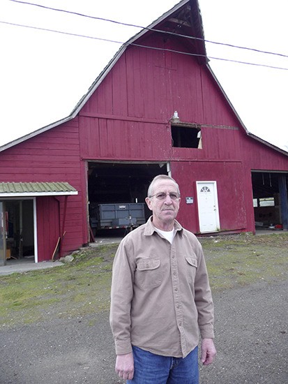Barn owner Mark Smith poses in front of the 1940s-era barn.