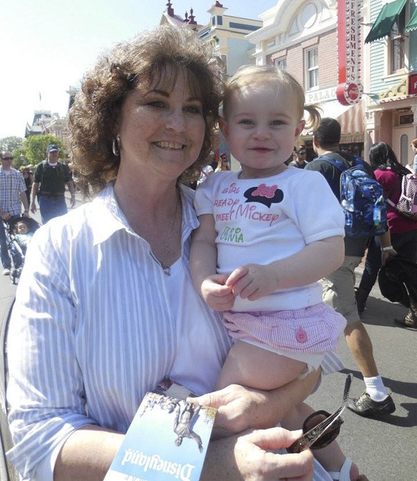 Cheryl Ghere and her granddaughter Olivia walk the streets of Disneyland for the first time together. Ghere said one of her goals was for her new granddaughters to see Mickey Mouse and the castle for the first time.