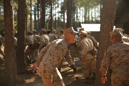 Staff Sgt. Tristan Curren motivates recruits to move faster in a recent drill.