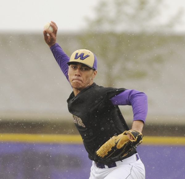Sequim's Nigel Christian pitches through wet conditions in an April league game against North Kitsap. He and the Wolves play in the West Central District tourney Saturday