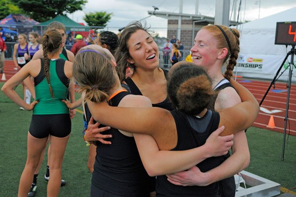 How is that for a finish? Sequim’s 4x400 relay team of (clockwise from far left) Gretchen Happe