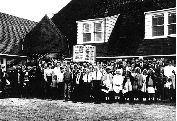 Church attendees of Sequim Bible Church gather outside the brick building where members met from 1964-1971. The congregation celebrates 50 years on Aug. 31 with special services and barbecue.