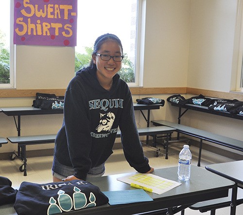 Eighth-grader Emily Glenn works the middle school sweatshirt station.