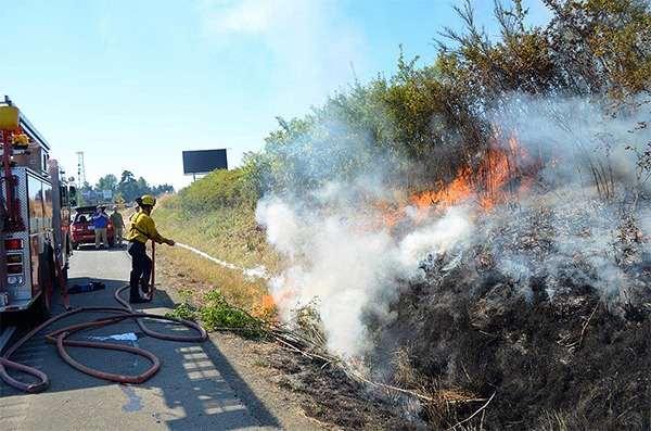 Clallam County District 3 firefighters quell a brush fire near U.S. Highway 101.