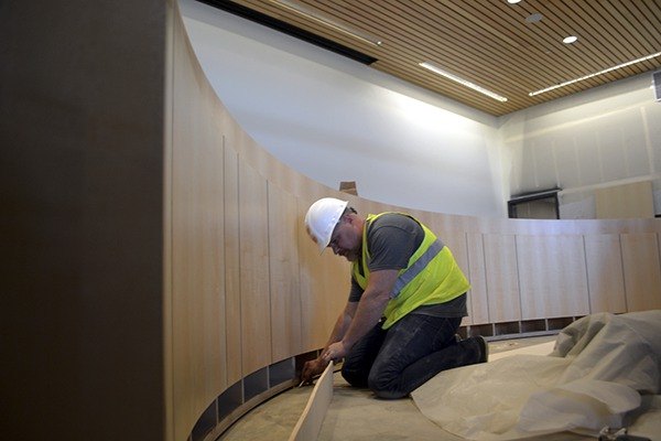 Todd Manchester with Bliemeisters' Wood Works looks to finish the podium in the Sequim City Council chambers on April 27. The Sequim company is installing all of the cabinets in the building.