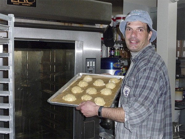 Artisan baker Russ Lewis displays a tray of lavender snickerdoodles that visitors to Bell Street Bakery can sample during the First Friday Art Walk.