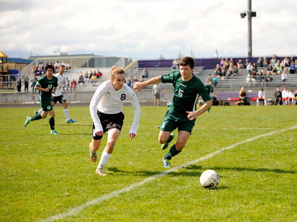 Sequim’s Liam Harris dribbles past Port Angeles’ Jeff Glatz late in the first half against PA. The Roughriders won 2-1 on March 26.