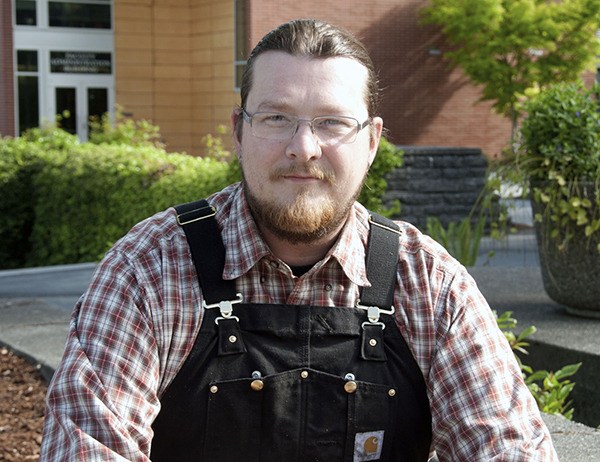 Justin VanBuskirk of Sequim stands in front of the welding facility on Peninsula College campus.
