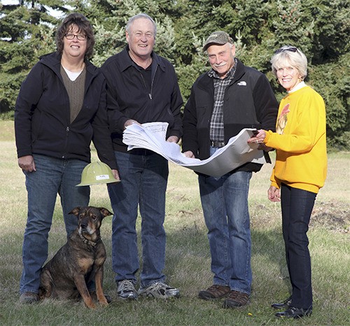 Buddy the Ambassadog meets with representatives to discuss construction of a dog kennel building for the Olympic Peninsula Humane Society. From left are Mary Beth Wegener