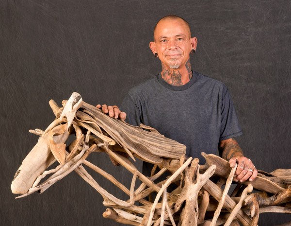 Artist David Tinsley continues to create driftwood art in the shape of people