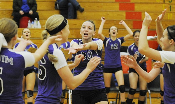 You excited? You bet. Sequim's Alyse Armstrong (30) celebrates teammate Ella Christensen's big block as the Wolves topped Olympic's Trojans on Saturday