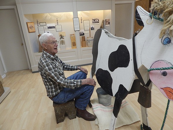 Bob Sorenson milks the plywood Holstein cow from the Bekkevars’ farm.