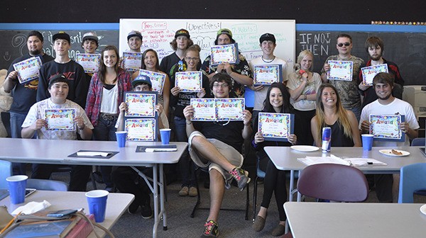 Alternative High School students enjoy sweet success with a pizza party. Front row (from left) are Joey Beeson