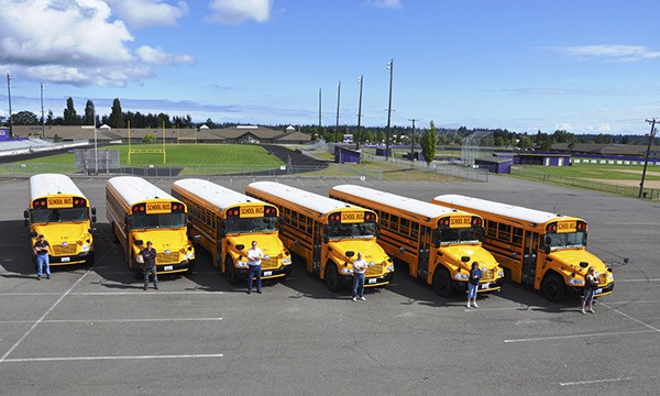 Six Sequim School District bus drivers stand by the newest additions to the fleet. Drivers include