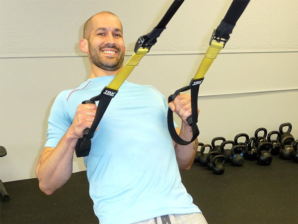 Personal trainer Matt Parks works out on the TRX straps in his gym StrongPoints Fitness. As a side note