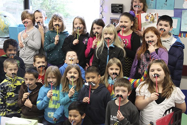 Second-graders in Tammy Owens’ class get inspired to have mustaches after reading a story.