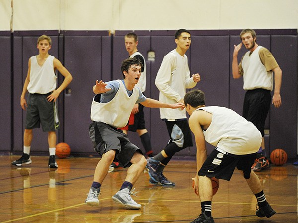 Sequim guard Alex Rutherforfd (center) applies some defensive pressure to Dylan Lott in a preseason drill. Rutherford and the Wolves tip off their season Dec. 5 at Klahowya. Looking on are (from left) teammates Jackson Oliver