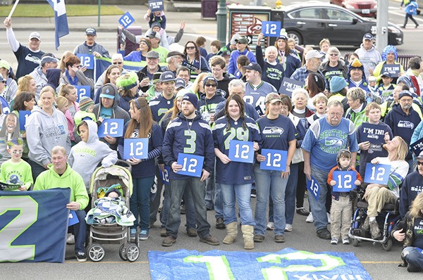Seattle Seahawks supporters gather in Centennial Place for a promotional photo supporting the team’s Super Bowl run in February.