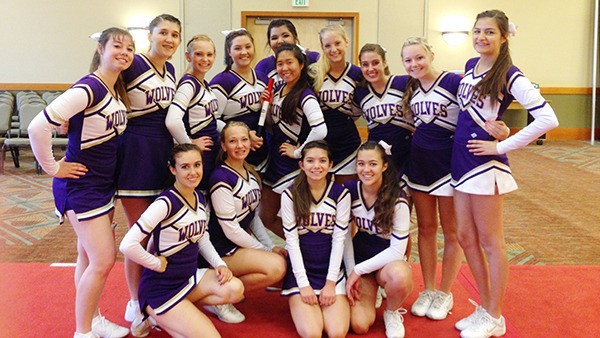 Sequim High School’s varsity cheer team celebrates with a “Spirit Stick” at a cheerleading conference at Great Wolf Lodge earlier this month. The squad includes (back row