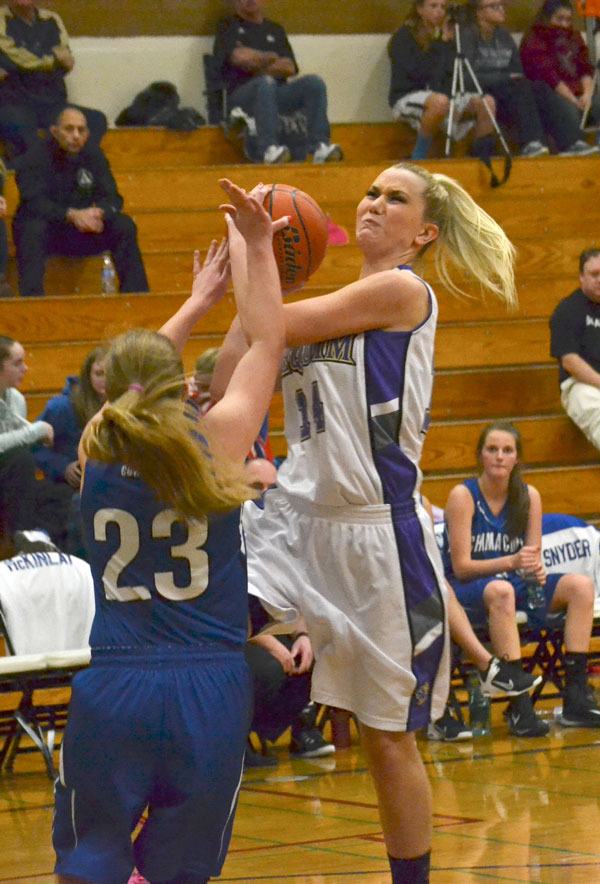Caitlin Stofferahn drives to the bucket while being fouled hard by Chimacum defenders on Jan. 14.