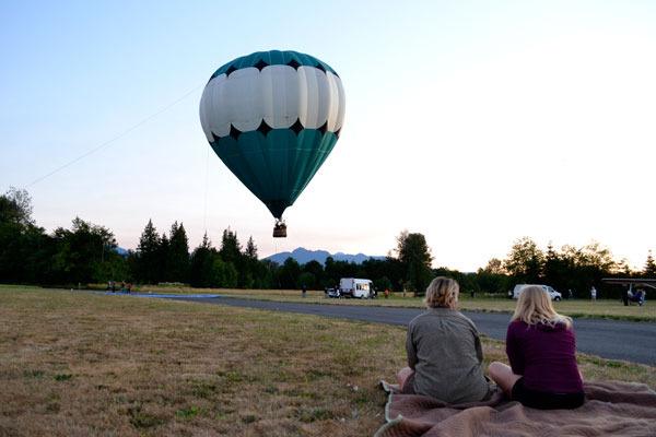 A crowd begins to form before the Moon Glow on July 31 at Sequim Valley Airport. Captain Crystal Stout plans to unite six hot air balloons for a night glow event on Aug. 29 at the airport with donations helping the Dream Catcher program that provides balloon rides to physically disabled people.