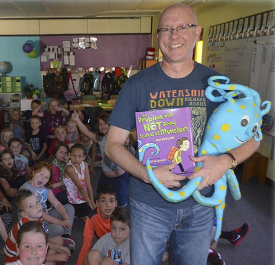 Author Dan Richards talks with students at Helen Haller Elementary School last month.