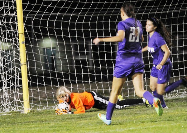 Claire Henninger makes a stop in her second game as goalie for the Sequim Wolves.