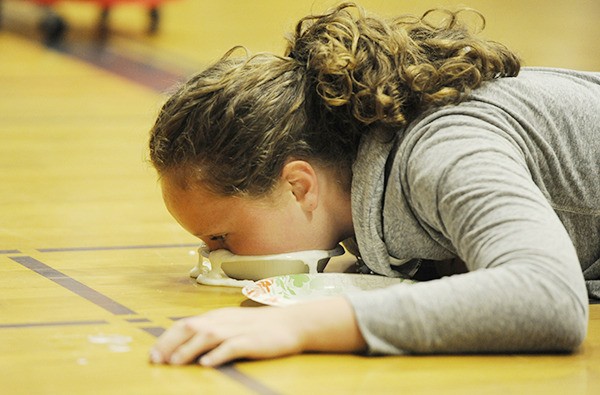 Eighth-grader Arlene Law goes all-in to win the Whipped Cream Race at last week’s Sequim Middle School Fear Factor Assembly on June 12.
