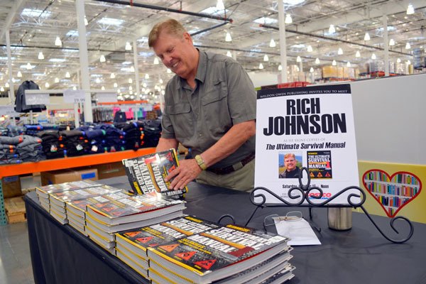 Sequim author Rich Johnson signs his “The Ultimate Survival Manual” in Sequim Costco on Oct. 17. He recently released his fictional thriller “Deadly Cargo” through Sarah Book Publishing.