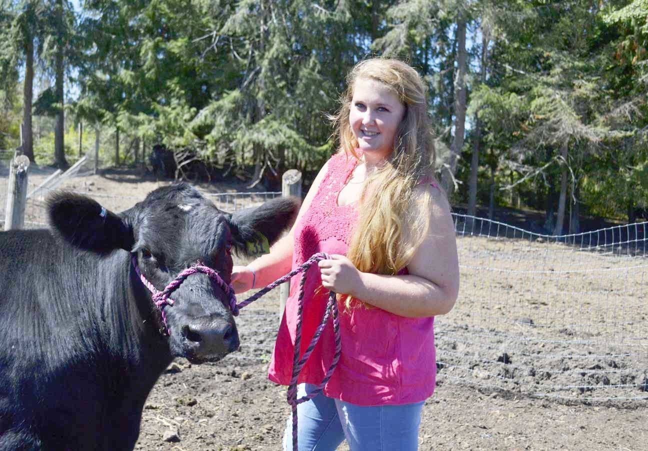 Bayleigh Carpenter of Sequim stands with her steer Lamborghini