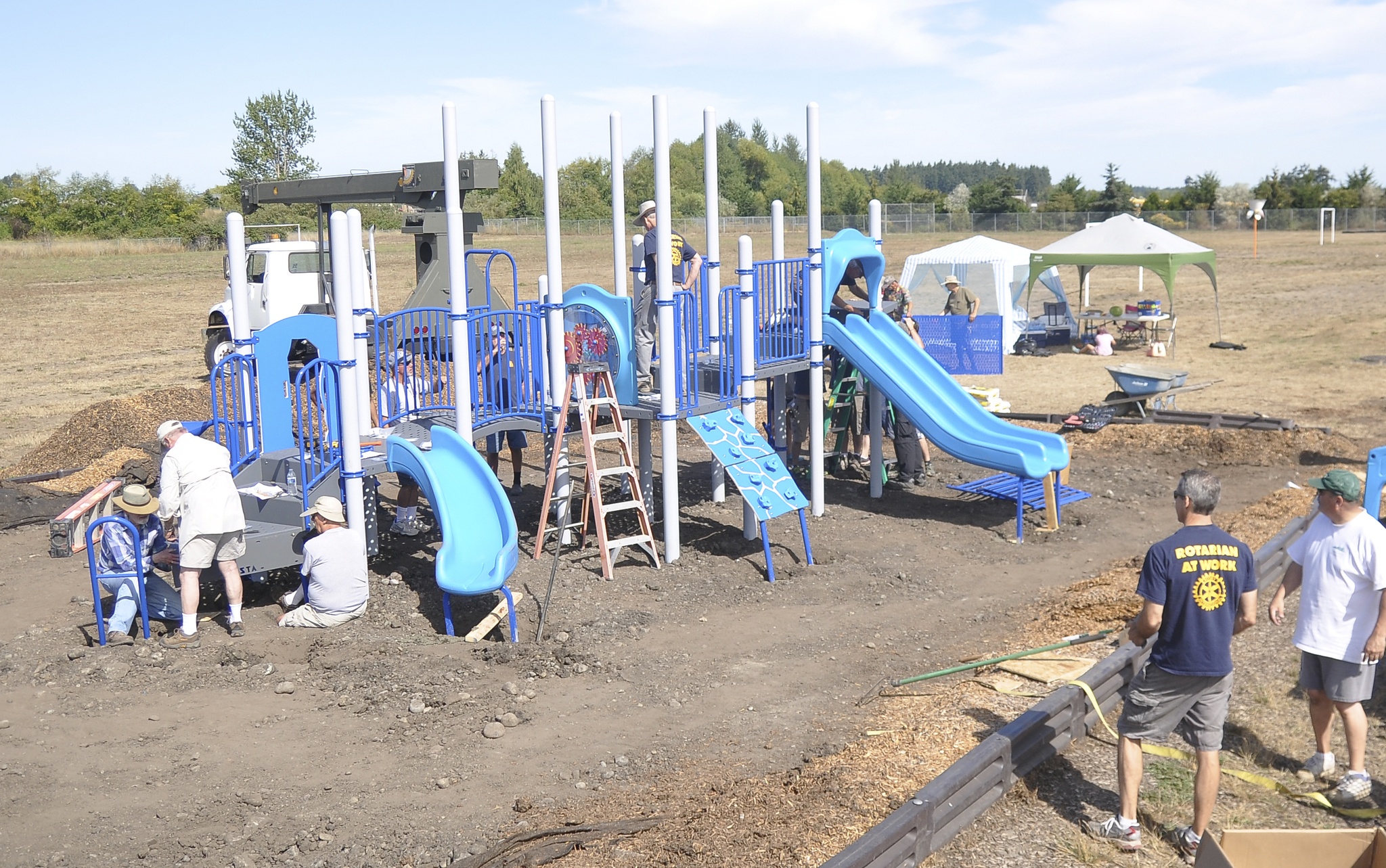 Community members come together to help construct playground equipment at Greywolf Elementary School in Carlsborg. Sequim Gazette photo by Michael Dashiell