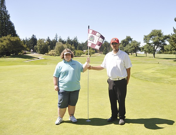 Amanda Forbes and Scott Aughtry take a short break during a practice round at The Cedars at Dungeness last week. The pair look for a state golf title at the Special Olympics’ Summer Sports Classic