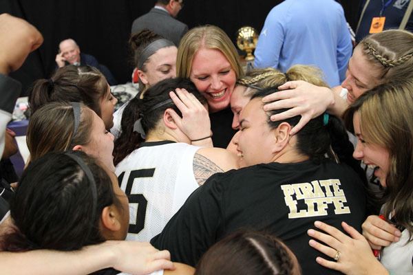 Peninsula College coach Alison Crumb celebrates an NWAC basketball title with her players in March.
