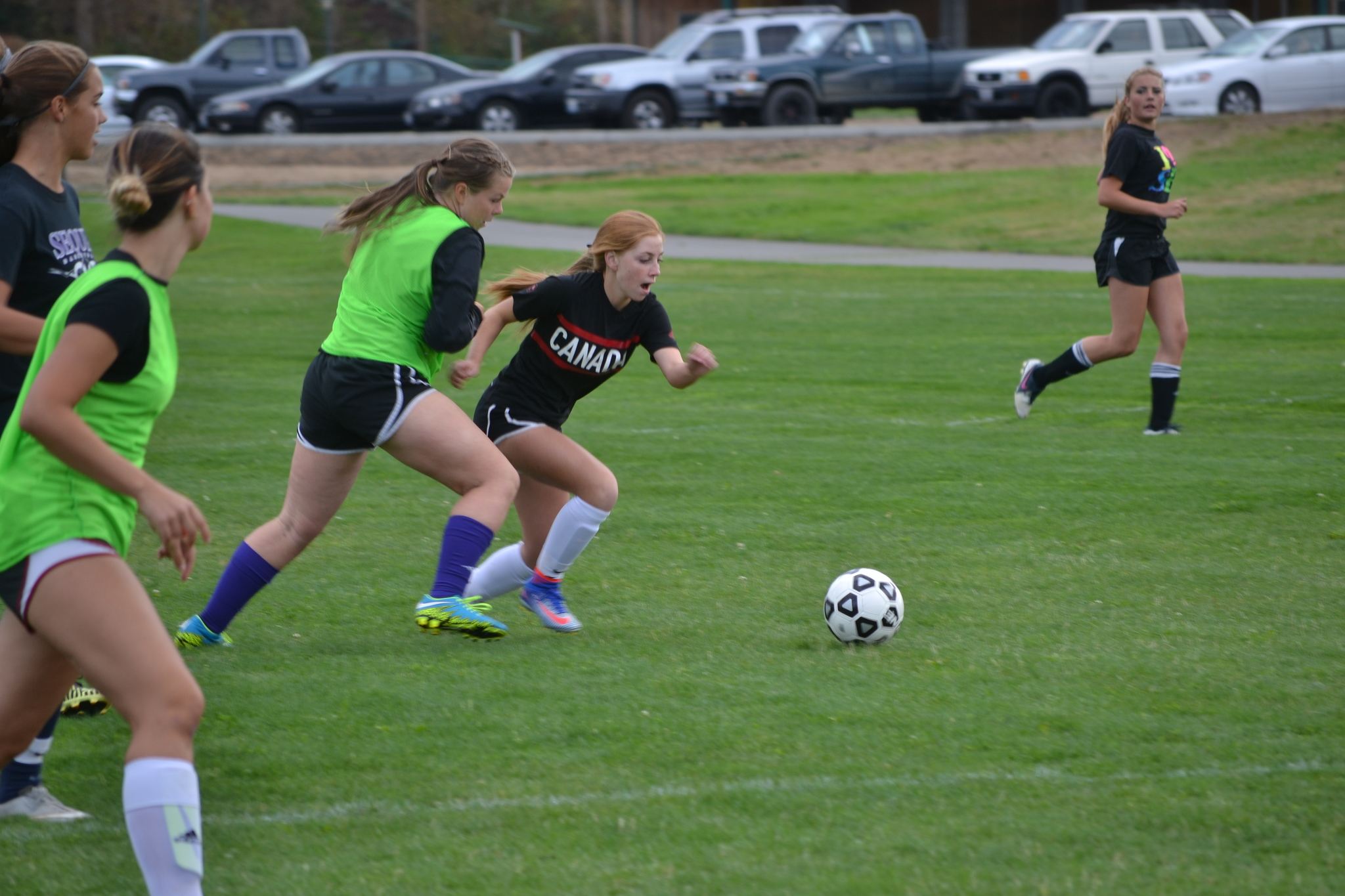 Daisy Ryan works the ball past defender Sarah Shea in a recent practice for the Lady Wolves soccer team. Sequim Gazette photo by Matthew Nash