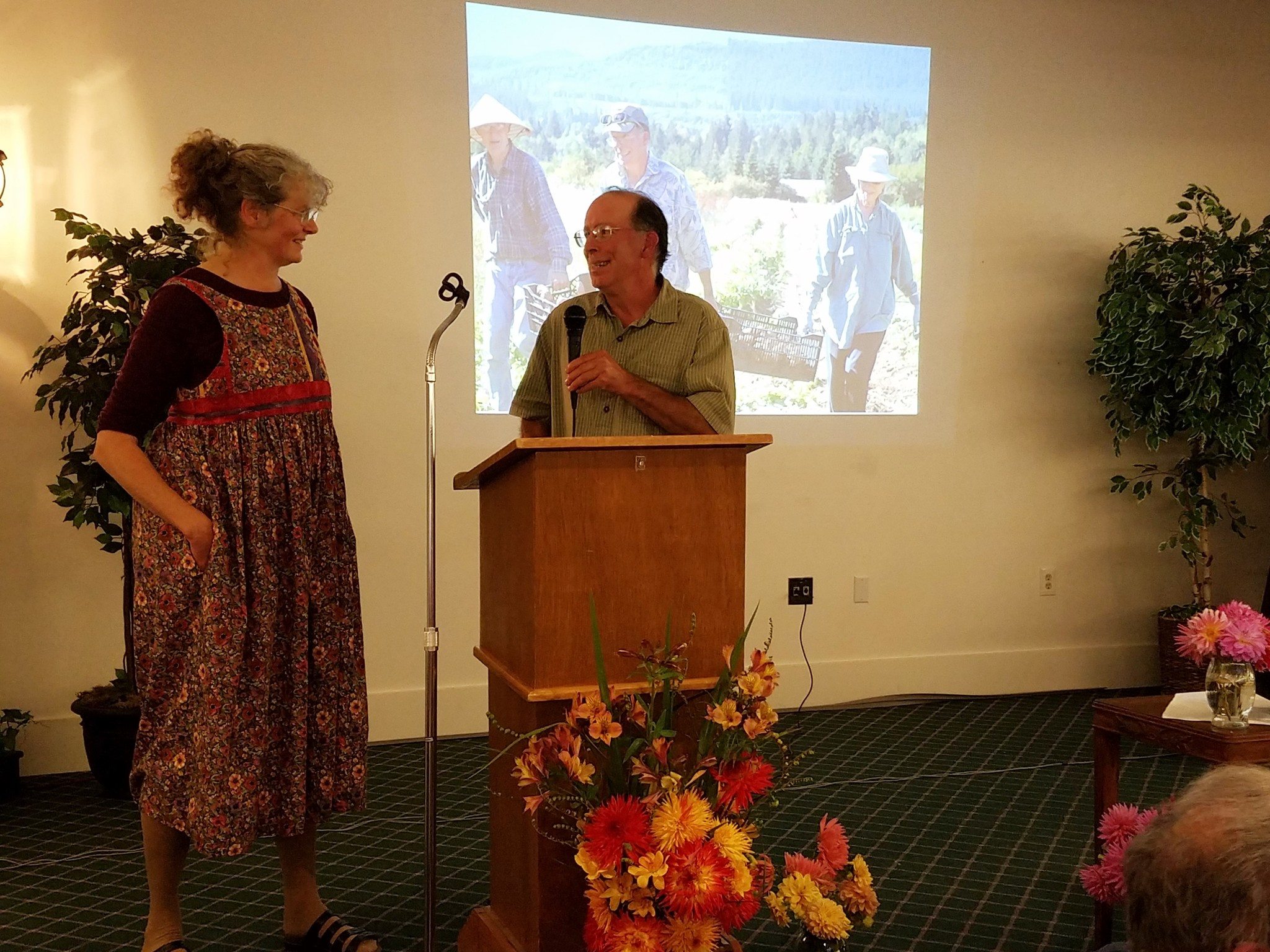 Owners of Salt Creek Farm Lee Norton and Doug Hendrickson on stage at Harvest Dinner to receive the 2016 Farmer of the Year award for their work to foster CSA across Clallam County. Submitted photo