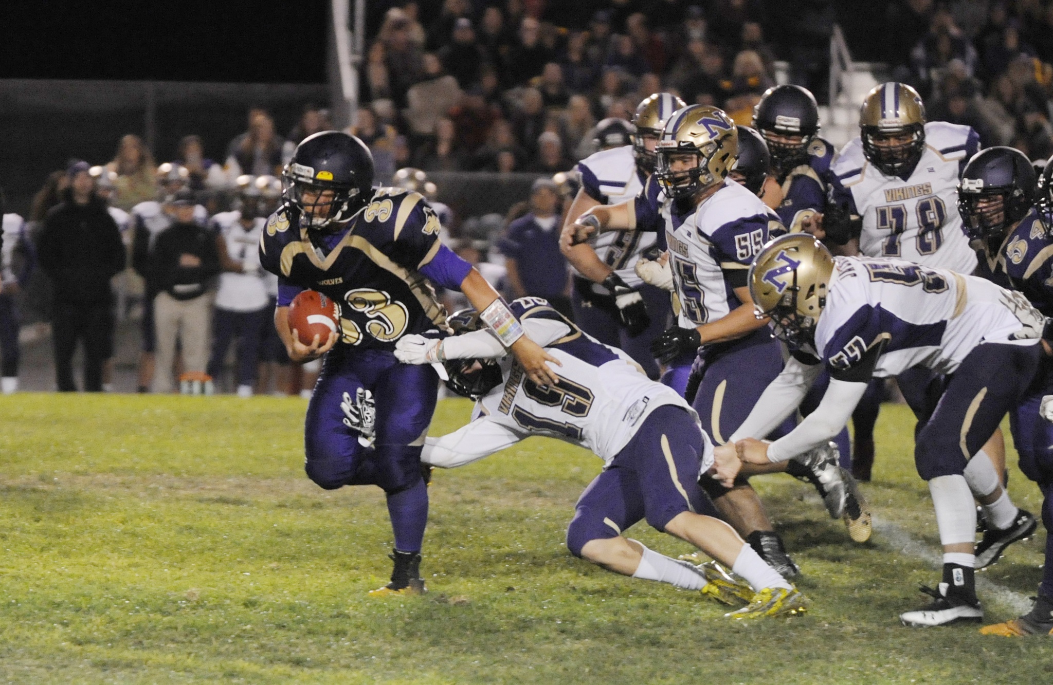 Sequim's Rudy Whitehead breaks free from Viking Zach Clark for a big gain in the second half of Sequim's 42-7 loss to North Kitsap on Sept. 30. Sequim Gazette photo by Michael Dashiell