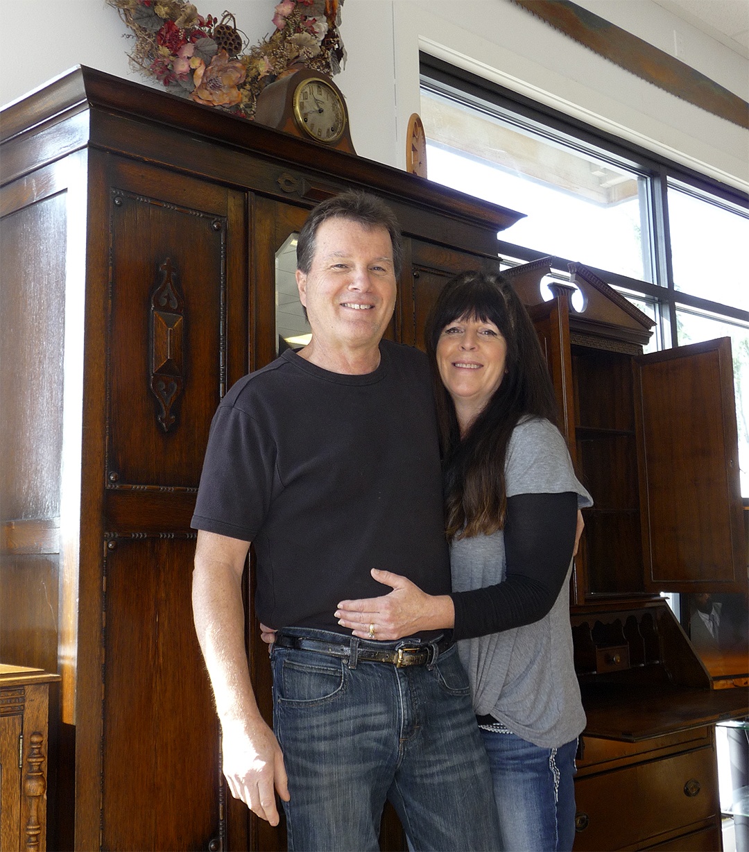 Mike Hardy and Lori Little pause in between customers by an English oak wardrobe at their new shop