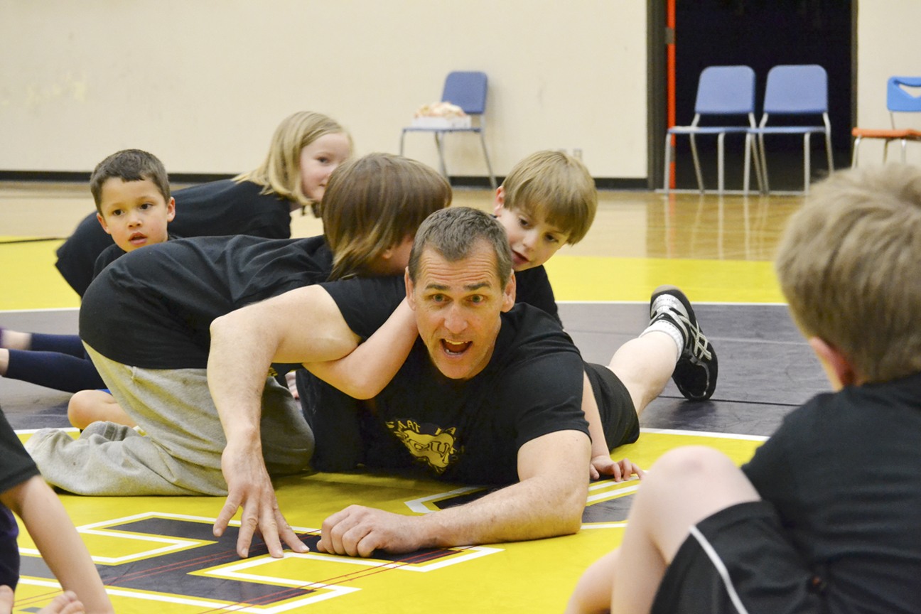 Sequim High wrestling coach Charles Drabek teaches a lesson to students about escaping a pin in the Mat Rats program