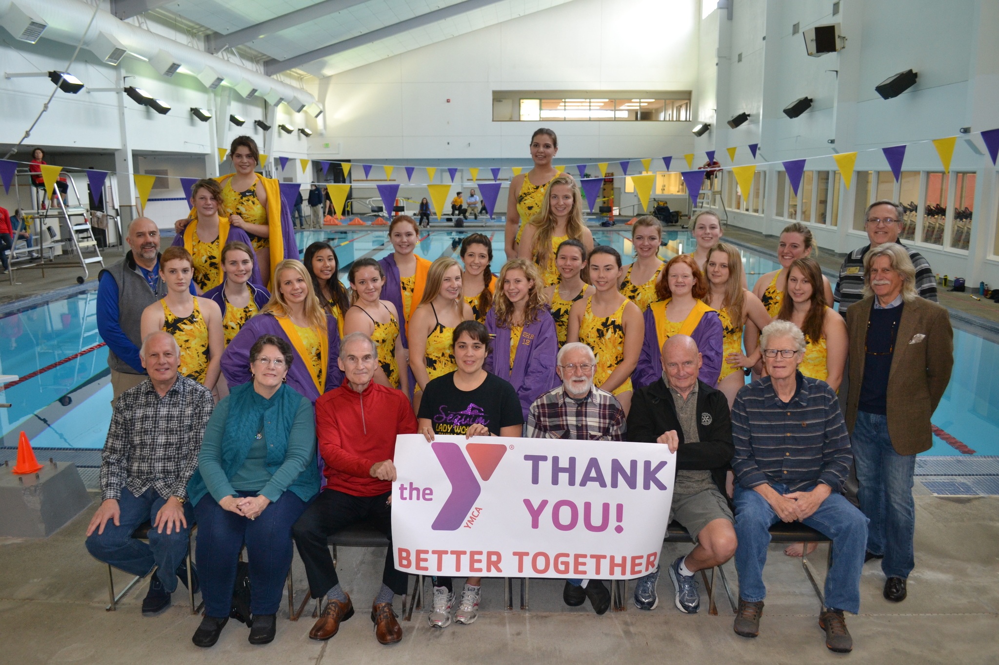 Sequim High School swim team members join the Olympic Peninsula YMCA board directors in celebrating the YMCA's recent fundraising campaign on Oct. 18. Sequim Gazette photo by Matthew Nash