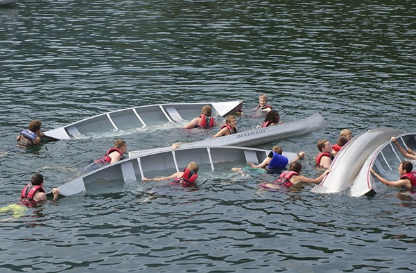 Members of Boy Scout Troop 1498 take part in a canoe swamp battle.