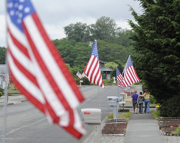 Sequim Sunrise Rotary Club’s flags line Fir Street on Memorial Day in 2013.