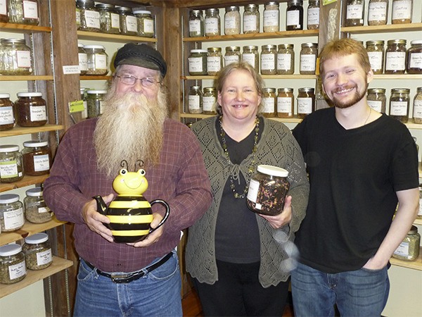 It’s a family affair — the Martins stand with scores of herbal teas on the left and dozens of medicinal herbs on the right. From left are Sequim Spice & Tea owners Marty and Char Martin and their son Anthony
