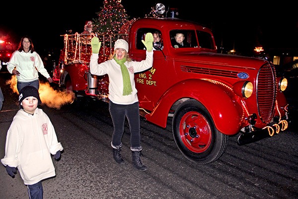 Santa Claus and the antique fire engine travel the roads of Sequim in 2012.
