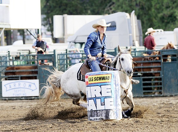 Kattie Hoffman of Sequim and her horse dig deep during the barrel racing portion of the 2014 Clallam County Fair rodeo.