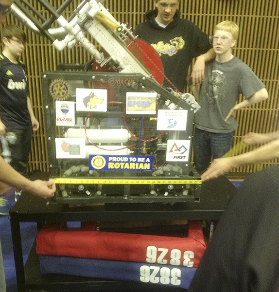 Sequim Robotics Club members wait while their robot is inspected at a competition in Auburn in March . Submitted photo