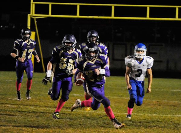 Sequim’s Gavin Velarde looks for running room after making a reception in Friday night’s 48-7 loss to Olympic.