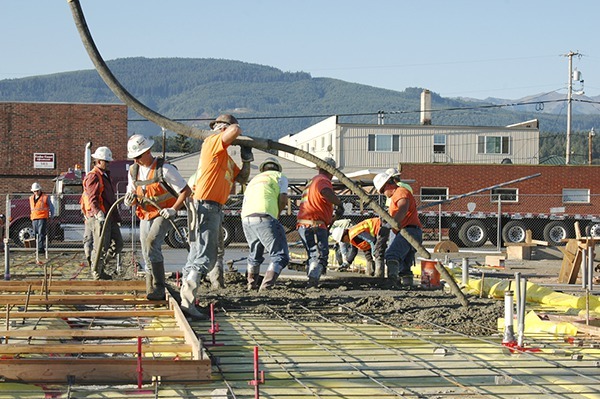Crews pour the first concrete in the early morning on July 30 at the new Sequim Civic Center. This week