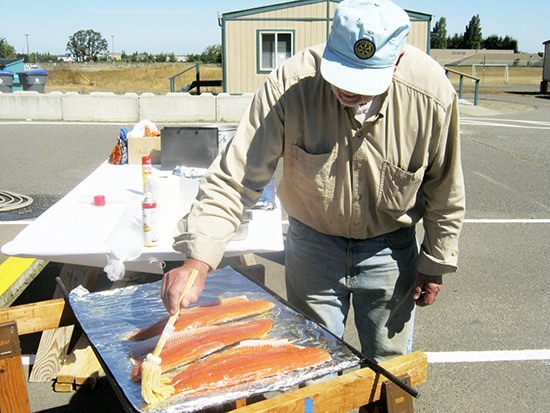 Cy Frick prepares some salmon at the 46th annual Sequim Noon Rotary’s Salmon Bake & BBQ. This year the event continues noon-4 p.m. Sunday