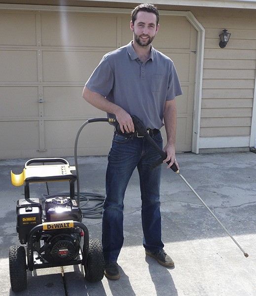 Michael Dunning of Dunning Pressure Washing demonstrates how he might spray a stained concrete driveway.