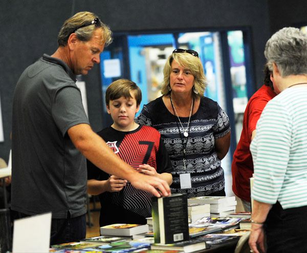 Lance and Marcia Bowden and son Jonathan peruse books at the 2014 Back to School Fair.